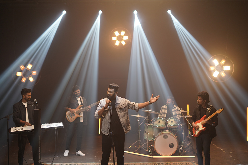 Winston David Prince Tamil Christian singer songwriter leading worship music on stage